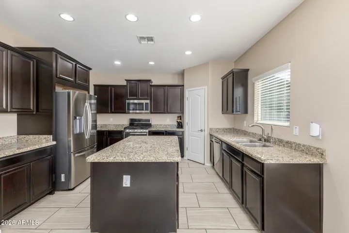 Kitchen with stacked cabinetry, granite, gas stove and fridge!
