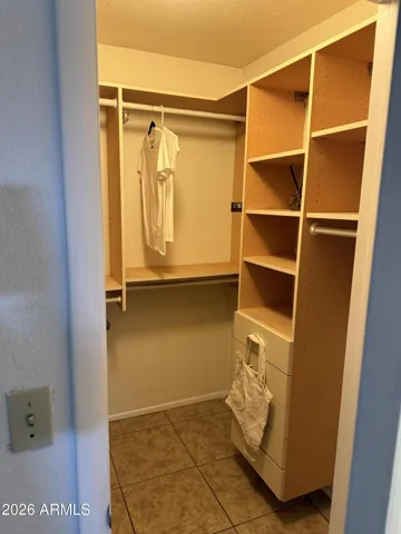 Custom primary closet with lots of storage