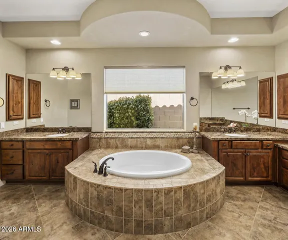 The Primary bath has dual vanities, soaking tub and walk in shower.