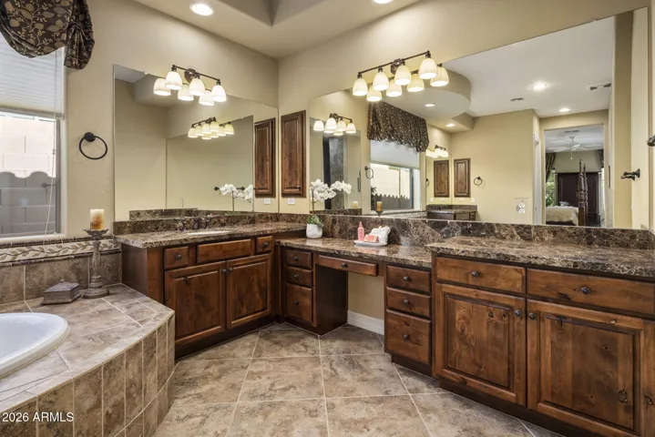 The Primary bath has dual vanities, soaking tub and walk in shower.