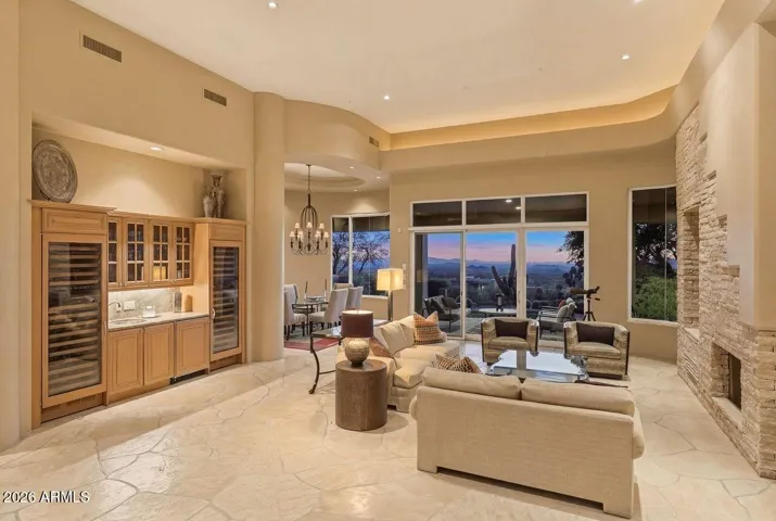 Expansive great room with flagstone flooring, fireplace, and large picture windows to take in the panoramic views