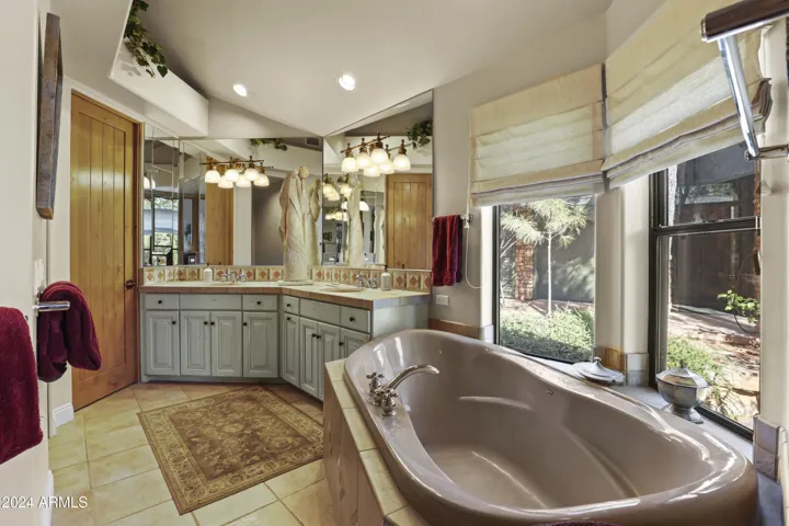 Master bath 1 has soaking tub, double vanity, walk in shower, water closet and large walk in closet with built ins.