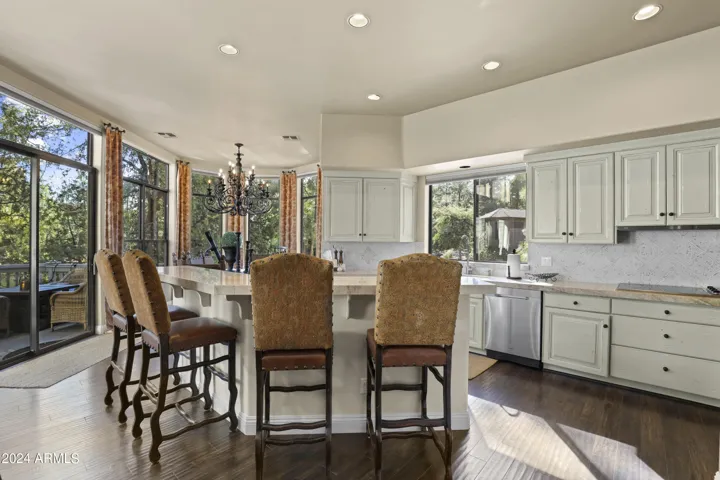Custom refinished cabinetry with breakfast bar and quartz countertops.