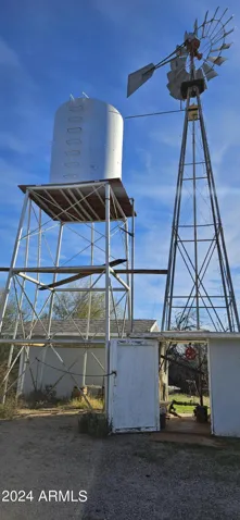 Well head with windmill and water tower.