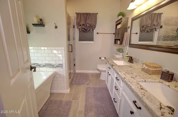 Master en-suite complete with double sinks, tile floors, updated lighting and window!