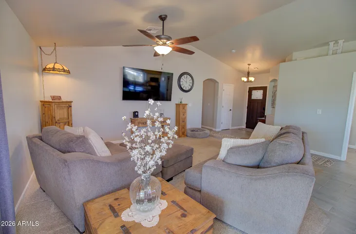 Great room with vaulted ceilings and wide entry way.