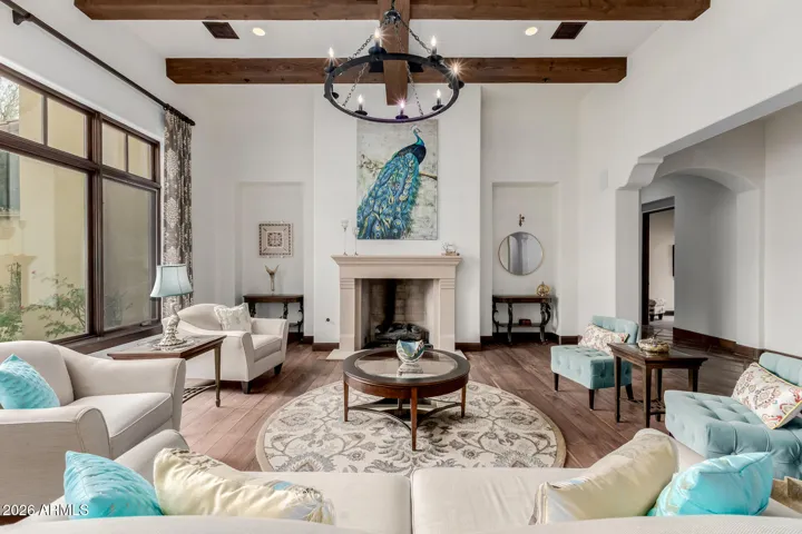 From the Dramatic Foyer to the Grand Living Room — Exposed Beams and a Striking Chandelier Create a Welcoming Statement.
