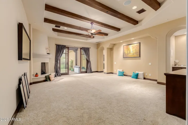 Large Primary Bedroom with Exposed Beams, & Plush Carpet.
