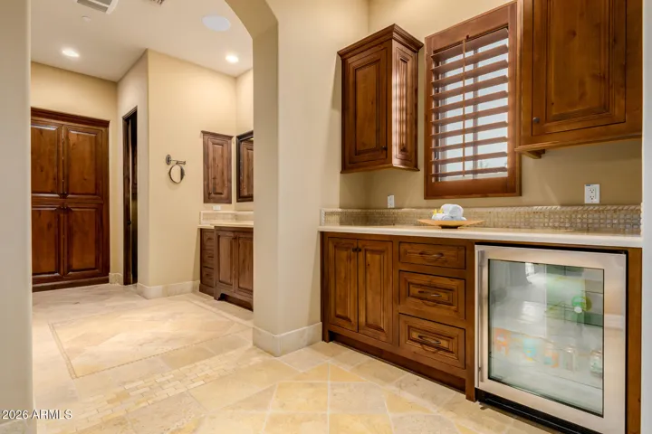 Beverage Fridge under Granite Counter Top and Cabinets separate His & Her Vanity Areas.