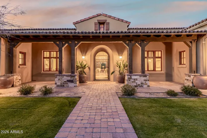 Grand Covered Porch with Clay Tile Roofing and Stately Pillars.