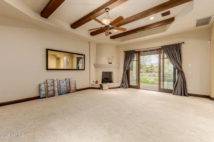 Semi Rounded Fireplace with Ledge makes a cozy reading area. Sliding Door opens to Owners' the patio and to the backyard.