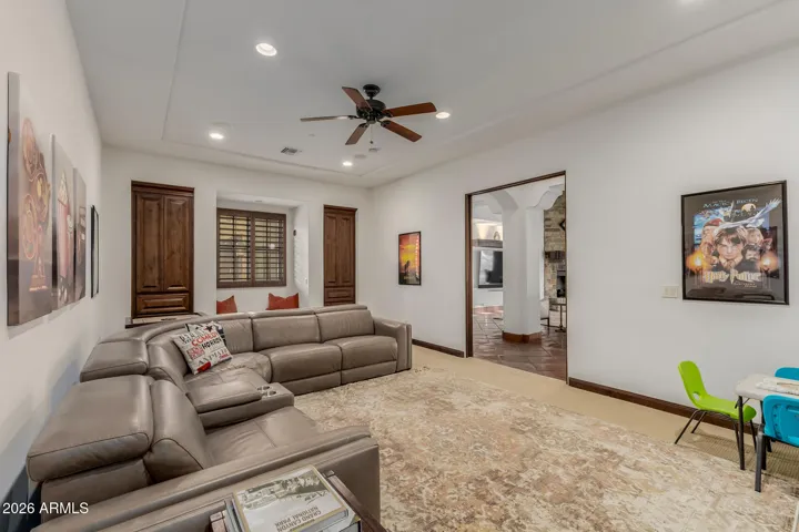 Media Room with Built in Cabinets, Window & Sliding Door that hides into the Wall.