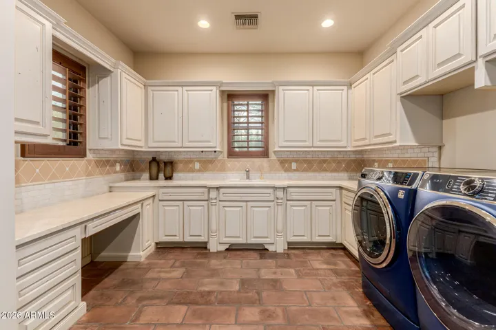 Large Laundry Room with with Custom Cabinets and Drawers. Ample Storage.