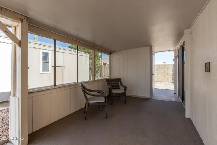 Covered seating area off the carport