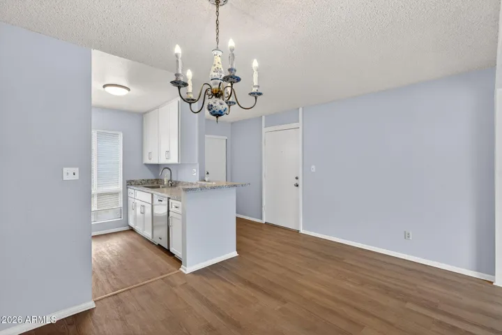 View of front door, kitchen and dining area