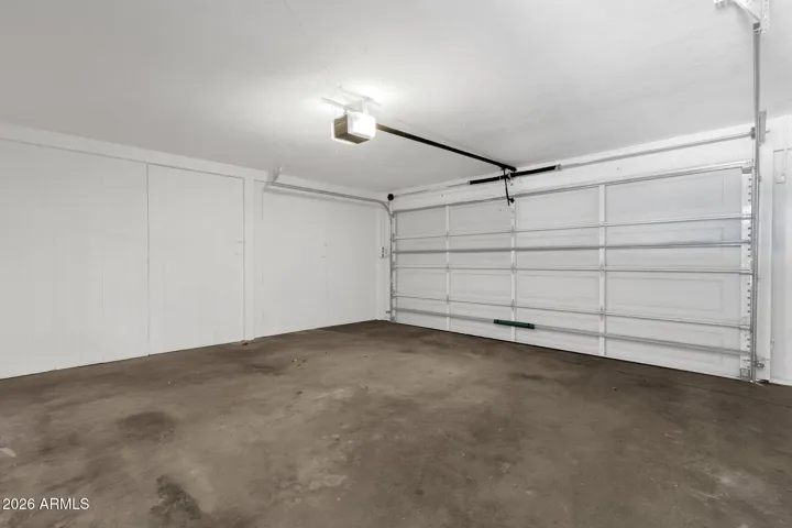 Two car garage with hidden storage access through wall