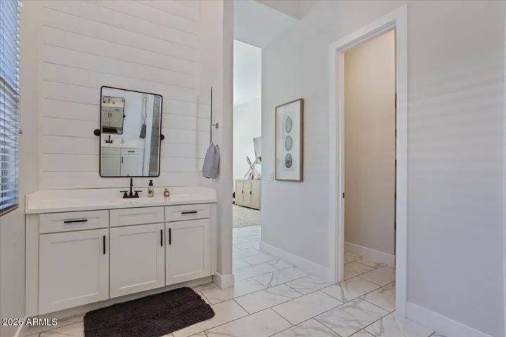 Dual vanities with ample counter space and storage for everyday convenience.