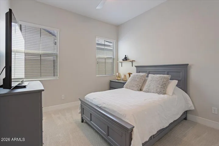 A bright and comfortable secondary bedroom with flexible use for guests, family, or a home office.