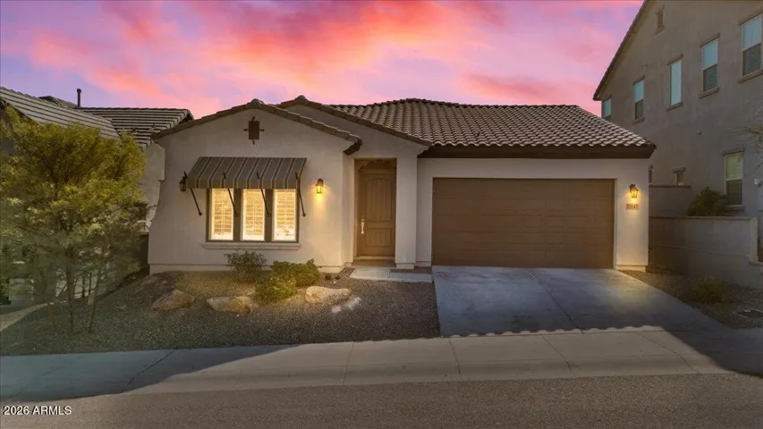 Dramatic evening lighting highlights the home’s curb appeal and architectural detail.