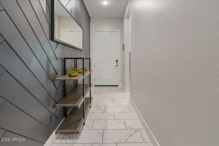 Thoughtful wall detailing adds character and visual interest to the home's interior entry