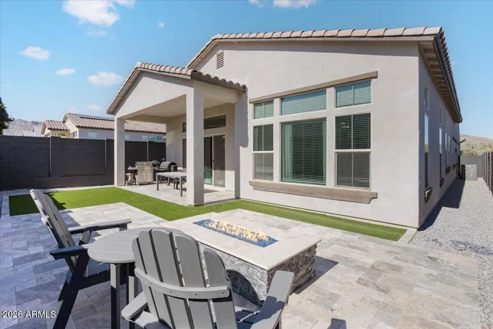 A private backyard with low-maintenance turf and patio space, ideal for relaxing or entertaining.