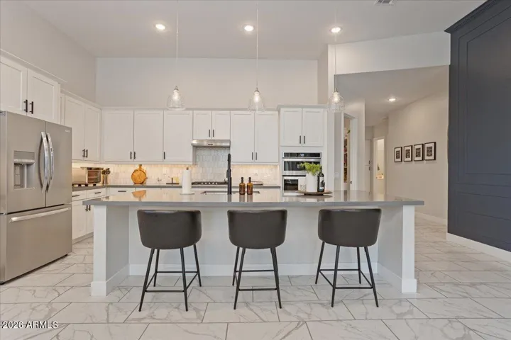 A functional kitchen layout with island seating—ideal for casual meals and everyday living.