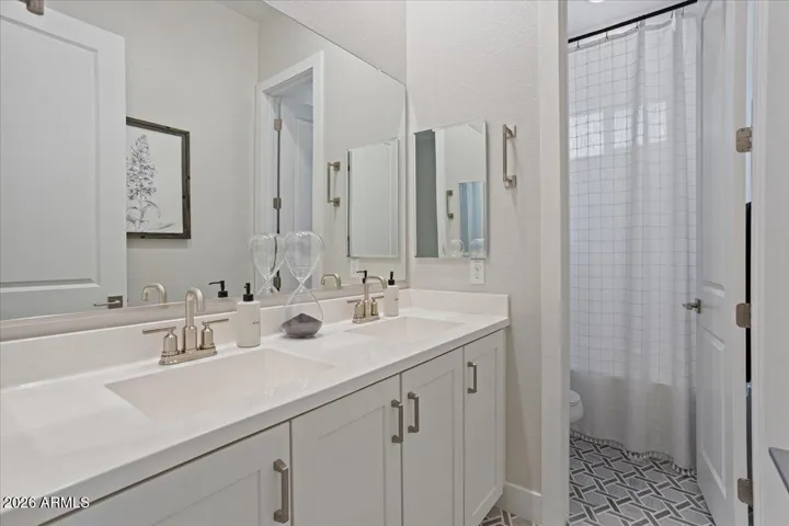 A well-appointed guest bathroom featuring elegant marble floors and timeless finishes.
