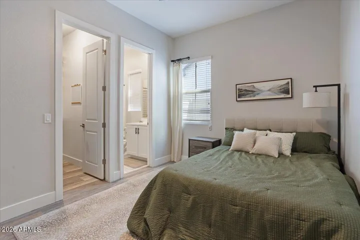 A comfortable secondary bedroom featuring its own en-suite bathroom, ideal for guests, extended family, or multigenerational living.