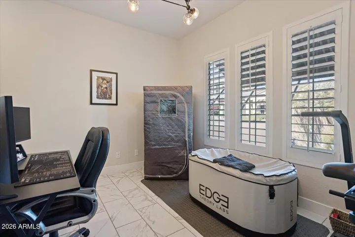 A versatile den offering flexible use as a home office, workout space, or additional living area.