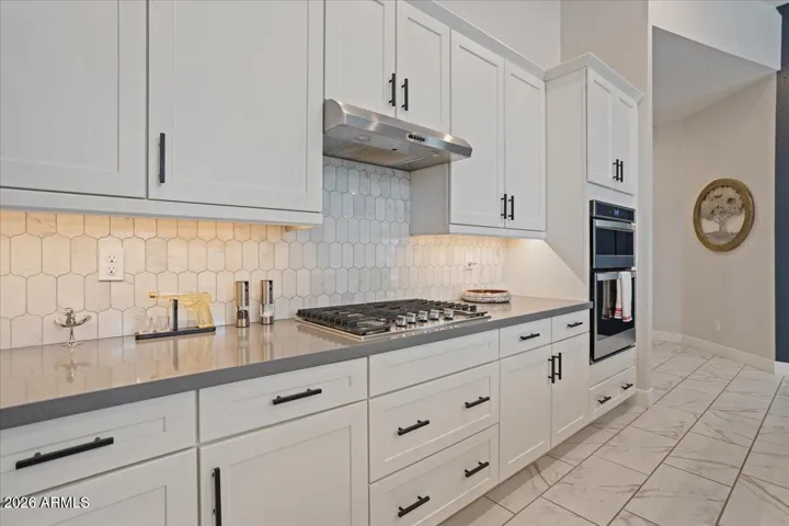 Clean finishes, quartz counters, gas cooktop, built-in oven and microwave, abundant storage, and a layout built for efficiency.