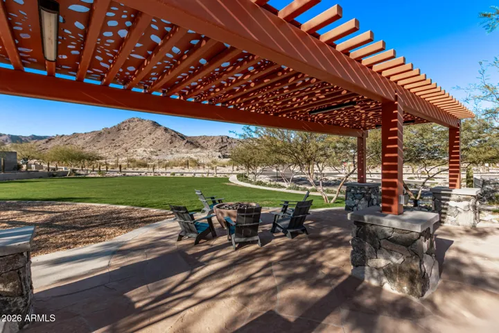 A thoughtfully designed community space featuring a pergola, seating, and scenic mountain views just outside your front door.