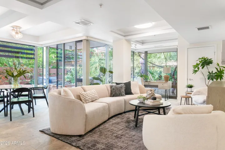 Open living room with automated Hunter Douglas window treatments