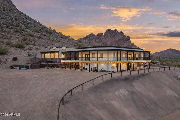 this modern Western estate offers exceptional scale, privacy, and architectural presence set against the dramatic San Tan Mountains. Situated on ~4 acres, the cohesive compound spans over 9,000 sq ft of combined living and functional space, featuring a thoughtfully designed main residence, multiple guest accommodations, and an expansive RV garage and shop with hookups. The updated black-and-white palette delivers a clean, sophisticated aesthetic that complements the surrounding desert landscape. Expansive covered patios, wraparound balconies, and inviting outdoor spaces create a seamless indoor-outdoor lifestyle, ideal for entertaining or multi-generational living—just minutes from Queen Creek amenities while offering a rare sense of seclusion.
