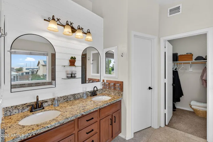 Primary bathroom with double sinks, toilet room, separate shower and bathtub, and 2 primary closets.