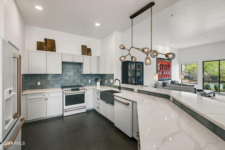 Designed for both daily living and entertaining, the kitchen opens directly to a breakfast bar and an adjacent breakfast nook, creating an inviting space for casual dining.