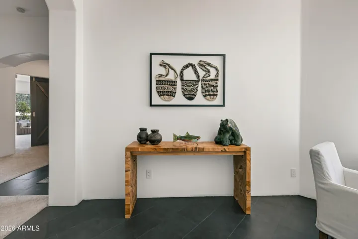 Gallery-Inspired Accents: Throughout the living spaces, including the foyer and main transition areas, you will find intentional art displays that add depth, character, and visual interest to the home's architecture.
