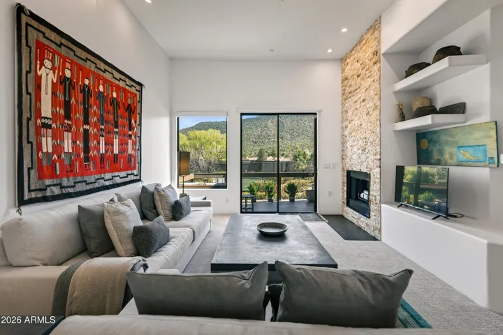 The Living Room is accentuated by a focal point fireplace and features dense carpeting for a comfortable, high-end feel.
