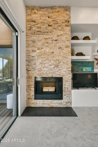 Striking Focal Point: The fireplace is accentuated by bricks, creating a rugged, high-end texture that anchors the living room and serves as a natural conversation starter.
