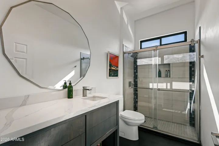 Modern Aesthetic: The space features a sleek, contemporary vanity setup that complements the home's overall design.