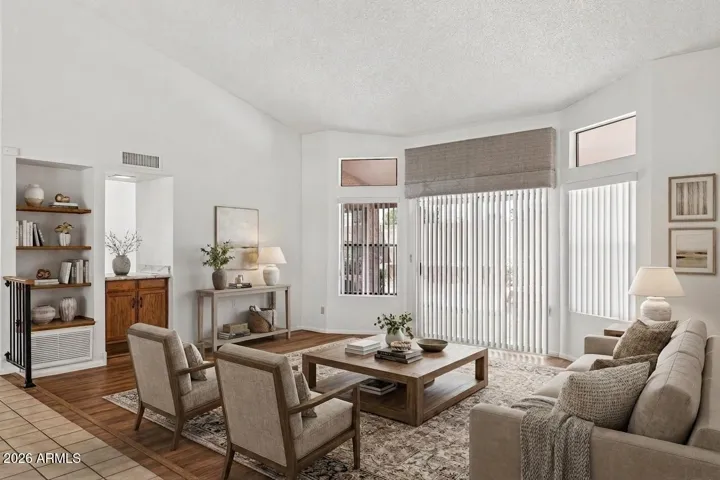 Vaulted front entry and great room with back patio access (virtually staged)