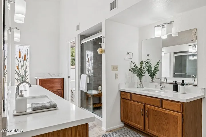 Owner's suite bath with upgraded counters, split sink layout, enclosed water closet, extra large shower (virtually staged)