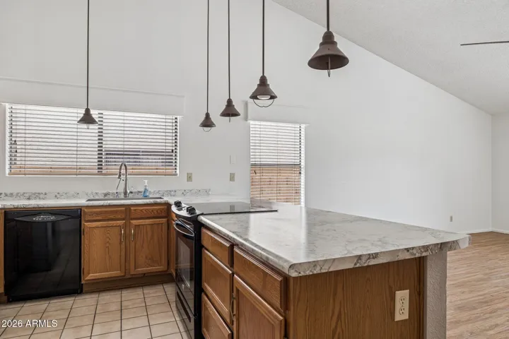 Kitchen with smooth-surface range, dishwasher, refrigerator, disposal