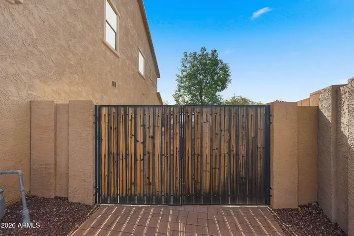 Pavers extend to side yard behind large RV gate