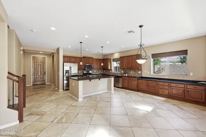 Large open and airy kitchen showing a banquet counter with tons of storage cabinets