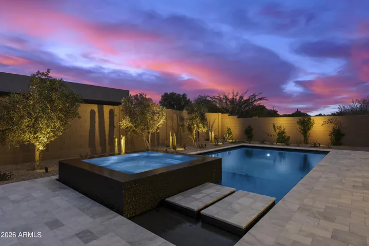 Elevated zero edge spa with floating steps to access.