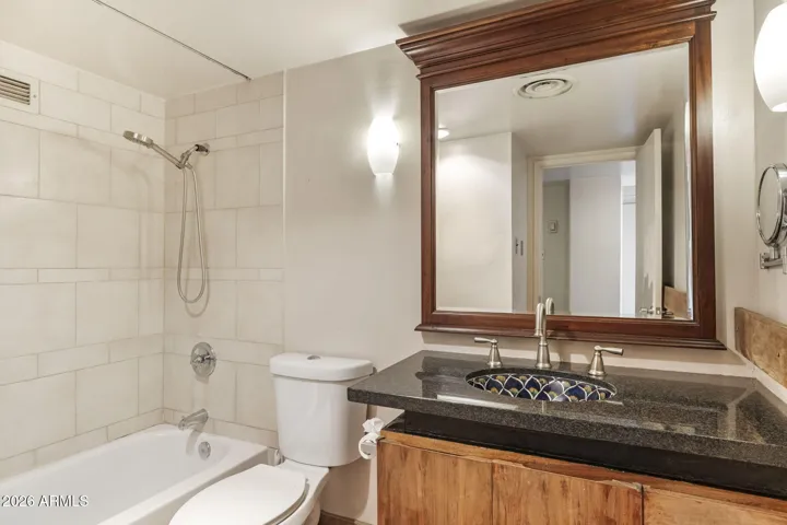 Updated bathroom with raised vanity, decorative vessel sink.