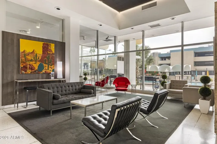 Additional lobby gathering space with modern furnishings and pool views.