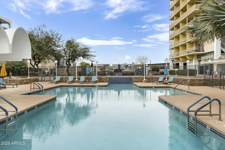 Resort-style pool with ample lounging space and high-rise backdrop.