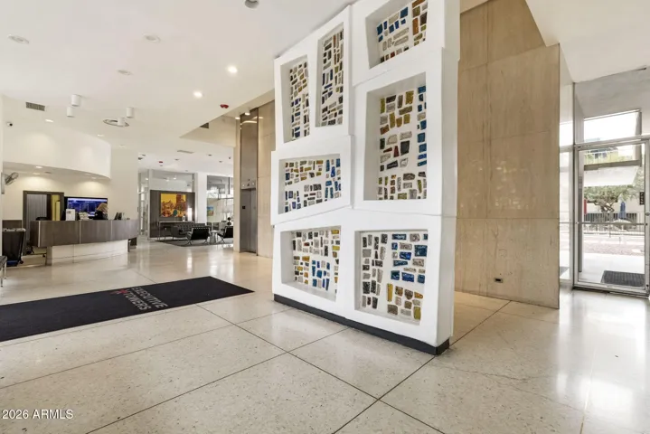 Original mid-century mosaic and architectural features in the secured lobby.