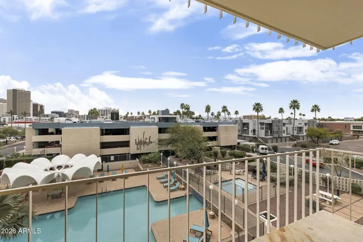 Private balcony offering mountain views by day and downtown city lights by night.